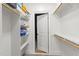 Spacious walk-in closet featuring custom shelving, ample storage, and a neutral color palette at 3016 Allansford Ln, Raleigh, NC 27613