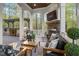 Inviting covered deck with an outdoor kitchen, fireplace, and comfortable seating area at 3016 Allansford Ln, Raleigh, NC 27613