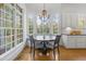 Cozy dining area with natural light, features a large window, breakfast nook and chandelier at 3016 Allansford Ln, Raleigh, NC 27613