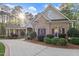 Beautiful brick home featuring manicured landscaping, a covered porch, and a curved driveway at 3016 Allansford Ln, Raleigh, NC 27613