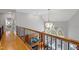 Elegant foyer with a wooden railing overlooking a living area with a large window and modern decor at 3016 Allansford Ln, Raleigh, NC 27613