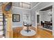 Stately foyer featuring hardwood floors, a staircase, a decorative table, and views into other rooms at 3016 Allansford Ln, Raleigh, NC 27613
