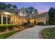 Beautiful home exterior with brick and siding, a covered porch, manicured landscaping and a circular driveway at 3016 Allansford Ln, Raleigh, NC 27613