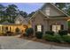 Charming home exterior featuring brick accents, black shutters, manicured landscaping, and a covered front porch at 3016 Allansford Ln, Raleigh, NC 27613