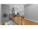 Bright hallway with hardwood floors, decorative railing, and a view into a cozy sitting area at 3016 Allansford Ln, Raleigh, NC 27613
