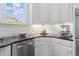 Kitchen featuring white cabinets, stainless steel appliances, plenty of counter space, and ample natural light at 3016 Allansford Ln, Raleigh, NC 27613