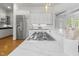 Kitchen features white countertops, stainless steel appliances, ample counter space and a gas range on the island at 3016 Allansford Ln, Raleigh, NC 27613