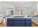 Open kitchen with a large island including gas range, bright lighting and seamless access to other living areas at 3016 Allansford Ln, Raleigh, NC 27613