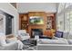 Inviting living room with fireplace, built-in shelving, hardwood floors, and large windows at 3016 Allansford Ln, Raleigh, NC 27613