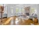 Light-filled living room featuring a stone fireplace, hardwood floors, and a patio door at 3016 Allansford Ln, Raleigh, NC 27613