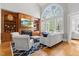Bright living room with large arched windows, hardwood floors, fireplace and built-in shelving at 3016 Allansford Ln, Raleigh, NC 27613