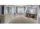 Large main bedroom with carpet floors, a seating area, large windows, and a desk at 3016 Allansford Ln, Raleigh, NC 27613
