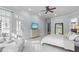 Bright main bedroom with sitting area, ceiling fan, and door to a balcony at 3016 Allansford Ln, Raleigh, NC 27613