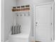 Mudroom features a bench, storage, hooks and an exterior door at 3016 Allansford Ln, Raleigh, NC 27613