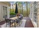 Charming outdoor dining area with a wrought iron table and chairs, surrounded by lush landscaping at 3016 Allansford Ln, Raleigh, NC 27613