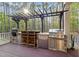 Outdoor kitchen and grilling area on a wood deck surrounded by trees at 3016 Allansford Ln, Raleigh, NC 27613
