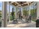 Cozy covered porch with rocking chairs and a small table, perfect for relaxing outdoors at 3016 Allansford Ln, Raleigh, NC 27613