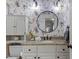 Charming powder room featuring floral wallpaper, granite countertop, mirror, and vanity with storage at 3016 Allansford Ln, Raleigh, NC 27613