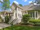 Well-manicured backyard with a spacious deck, patio, and lush landscaping surrounding the home at 3016 Allansford Ln, Raleigh, NC 27613