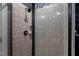 Walk-in shower featuring neutral tile, modern fixtures and dark trim at 3016 Allansford Ln, Raleigh, NC 27613