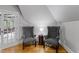 Charming sitting area with two upholstered chairs, a small table, and plenty of natural light at 3016 Allansford Ln, Raleigh, NC 27613