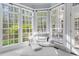 Cozy sunroom with cushioned seating, windows all around, and access to a deck at 3016 Allansford Ln, Raleigh, NC 27613