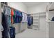Walk-in closet with custom shelving, rods, and organized clothing at 3016 Allansford Ln, Raleigh, NC 27613