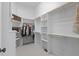 Spacious walk-in closet features custom shelving and plenty of room for storage and organization at 3016 Allansford Ln, Raleigh, NC 27613