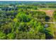 Lush aerial view highlights the property's wooded surroundings, offering a sense of privacy and natural beauty at 304 Westgate Cir, Angier, NC 27501