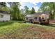 The backyard with deck and storage building enhances outdoor living at 304 Westgate Cir, Angier, NC 27501