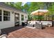 Back of house features a deck area with furnishings and an umbrella at 304 Westgate Cir, Angier, NC 27501
