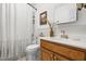 Bright bathroom featuring a pedestal sink, framed mirror, and shower tub combo at 304 Westgate Cir, Angier, NC 27501
