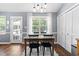 Light-filled dining room with a wooden table set and view to the backyard at 304 Westgate Cir, Angier, NC 27501