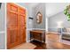 Inviting foyer featuring a wooden front door, hardwood floors, a vintage dresser, and a stylish gold mirror at 304 Westgate Cir, Angier, NC 27501