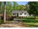 Exterior of a lovely home with a well-kept lawn, gravel driveway, and beautiful pink azalea bushes in the front at 304 Westgate Cir, Angier, NC 27501