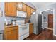 Well-lit kitchen features wooden cabinets, granite counters, and stainless steel appliances at 304 Westgate Cir, Angier, NC 27501