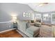 Spacious living room with vaulted ceiling, hardwood floors, fireplace, and comfortable sectional sofa with natural light at 304 Westgate Cir, Angier, NC 27501