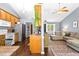 Open-concept living space combining the kitchen and living room with wood floors and a cozy sectional sofa at 304 Westgate Cir, Angier, NC 27501