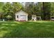 Backyard storage building with a playground set is perfect for families at 304 Westgate Cir, Angier, NC 27501