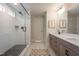 This bathroom features a glass enclosed shower, vanity mirror and double sinks at 306 White Magnolia Ln, Fuquay Varina, NC 27526