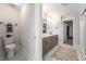 This bathroom features a toilet and double sinks, with a shower and closet through doorways at 306 White Magnolia Ln, Fuquay Varina, NC 27526
