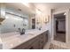 This bathroom features double sinks with a framed mirror, glass shower, and closet in view at 306 White Magnolia Ln, Fuquay Varina, NC 27526