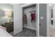 Bedroom closet boasts an organized storage system, carpeted floor, and bi-fold door at 306 White Magnolia Ln, Fuquay Varina, NC 27526