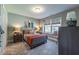 A well decorated bedroom featuring built in seating, wooden dresser, and carpet at 306 White Magnolia Ln, Fuquay Varina, NC 27526