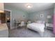 A bedroom with light green walls, white furniture, and wall art creates a comfy and inviting space at 306 White Magnolia Ln, Fuquay Varina, NC 27526