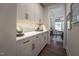 Butler's pantry boasts sleek white cabinetry, stainless steel hardware, and quartz counters at 306 White Magnolia Ln, Fuquay Varina, NC 27526