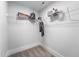 Organized closet with white wire shelving holding clothing, backpacks, and boxes against a neutral wall at 306 White Magnolia Ln, Fuquay Varina, NC 27526