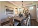 Well-lit dining room features neutral walls, modern decor, a wooden table, and seating for six at 306 White Magnolia Ln, Fuquay Varina, NC 27526