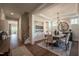Bright dining room area features hardwood floors, modern chandelier, and access to other living areas at 306 White Magnolia Ln, Fuquay Varina, NC 27526