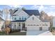 Beautiful two story home features a two car garage, covered porch, and professionally landscaped yard at 306 White Magnolia Ln, Fuquay Varina, NC 27526